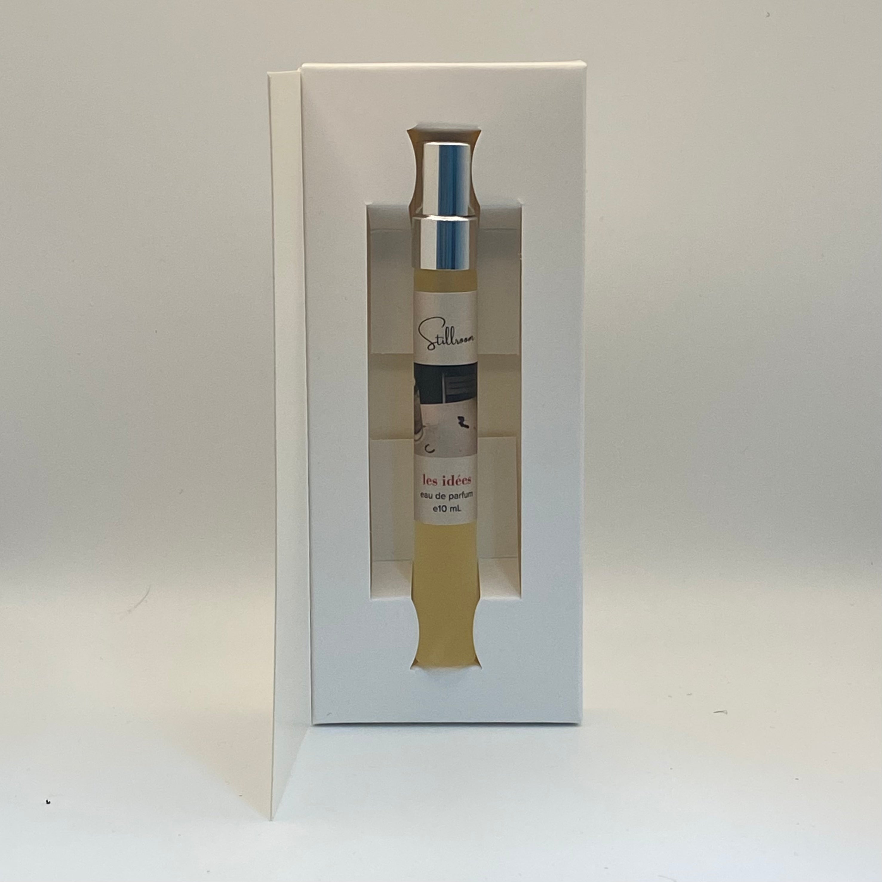 Small bottle with a label inside a white box on a light gray background